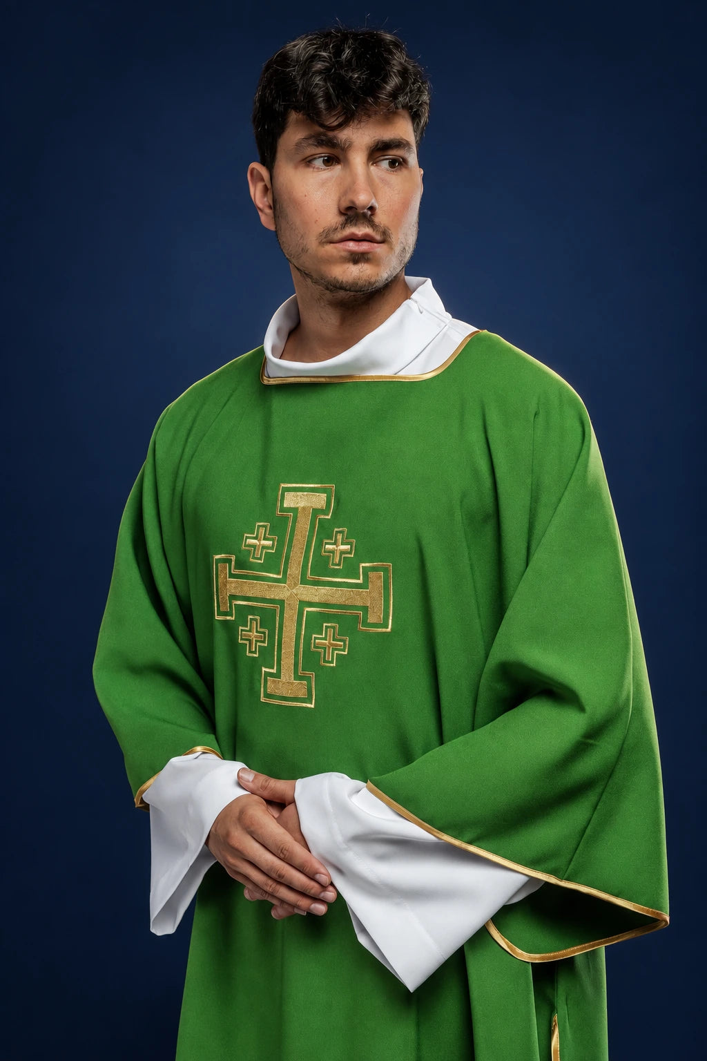 Front view of a green dalmatic with gold trim and a large embroidered gold cross on the chest
