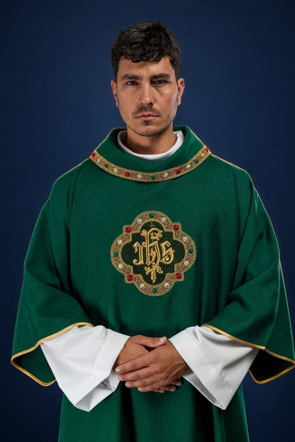 Front view of a green dalmatic with gold-trimmed collar and large IHS emblem on the chest