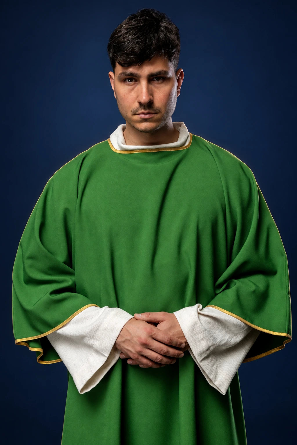 Front view of a green dalmatic with wide sleeves, white cuffs, and gold trim at the neck and hem