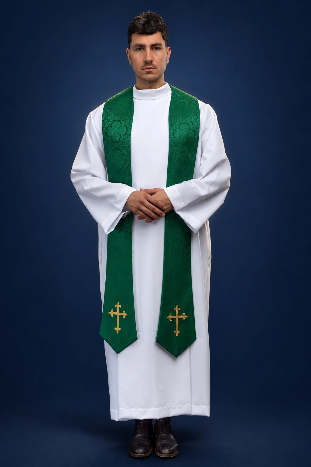 Front view of a green jacquard stole with embroidered cross motifs, worn over a white alb
