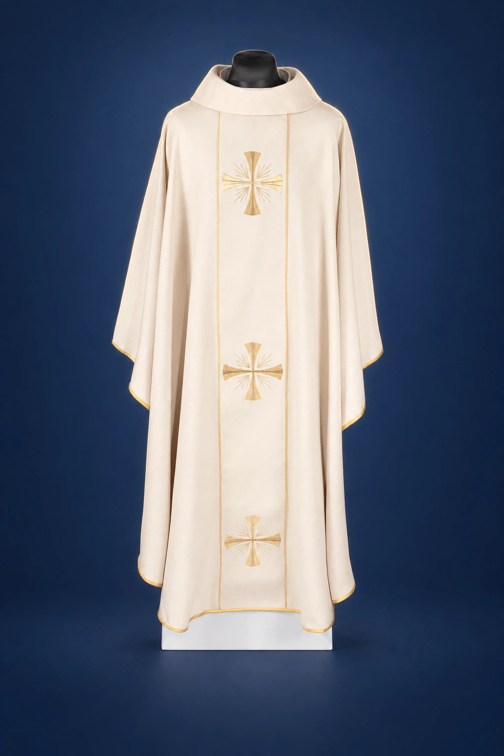 Front view of an ivory chasuble with ecru orphrey and three gold cross embroideries