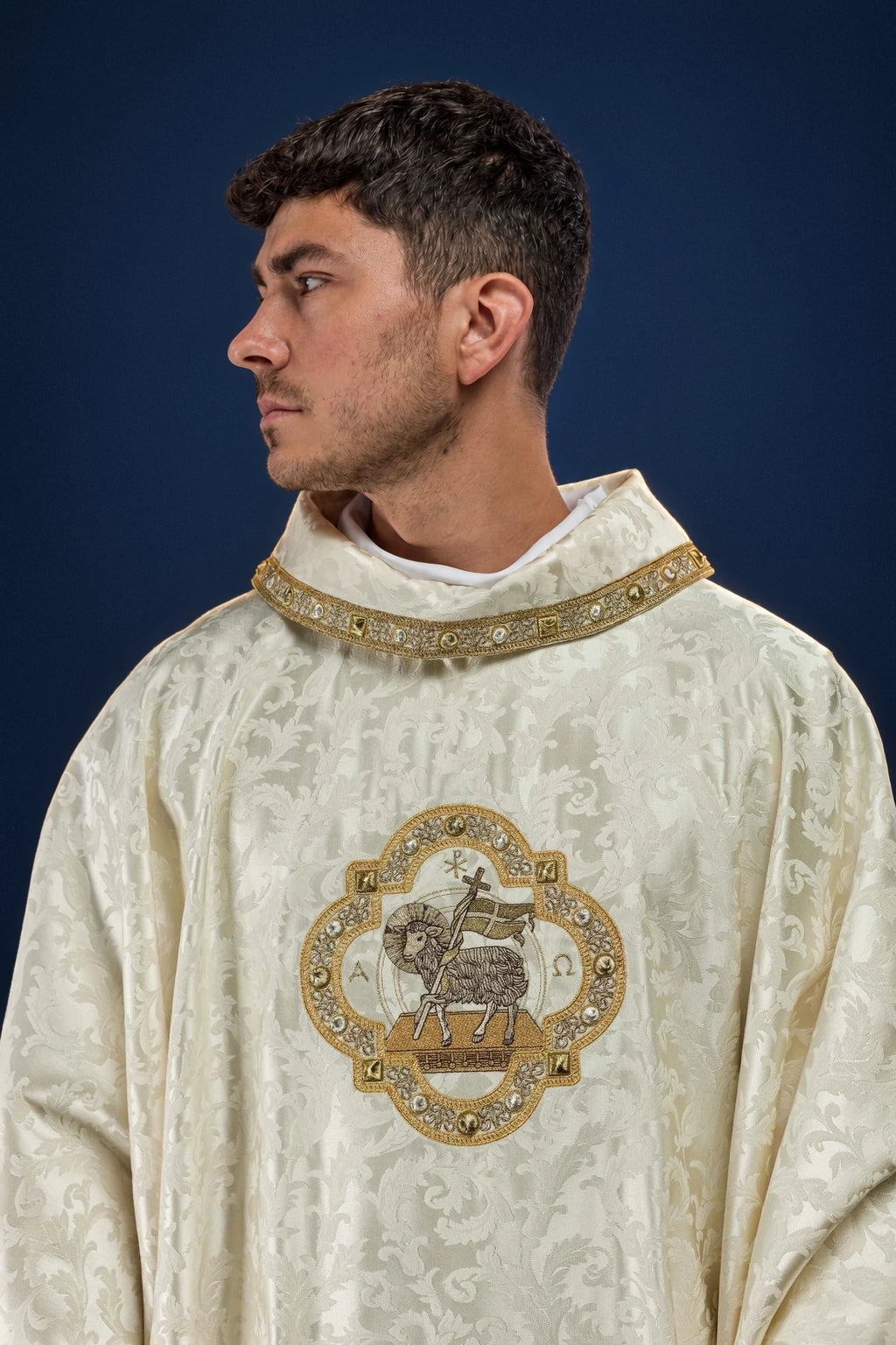 Front view of ivory chasuble with gold trim and central Paschal Lamb emblem