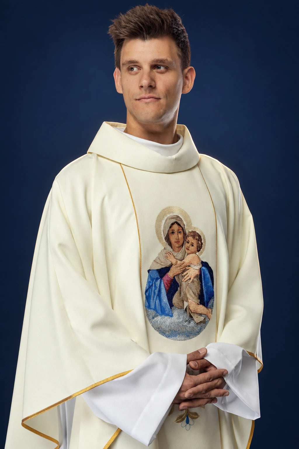 Front view of ivory chasuble with gold trim and embroidered Our Lady and Child medallion at chest