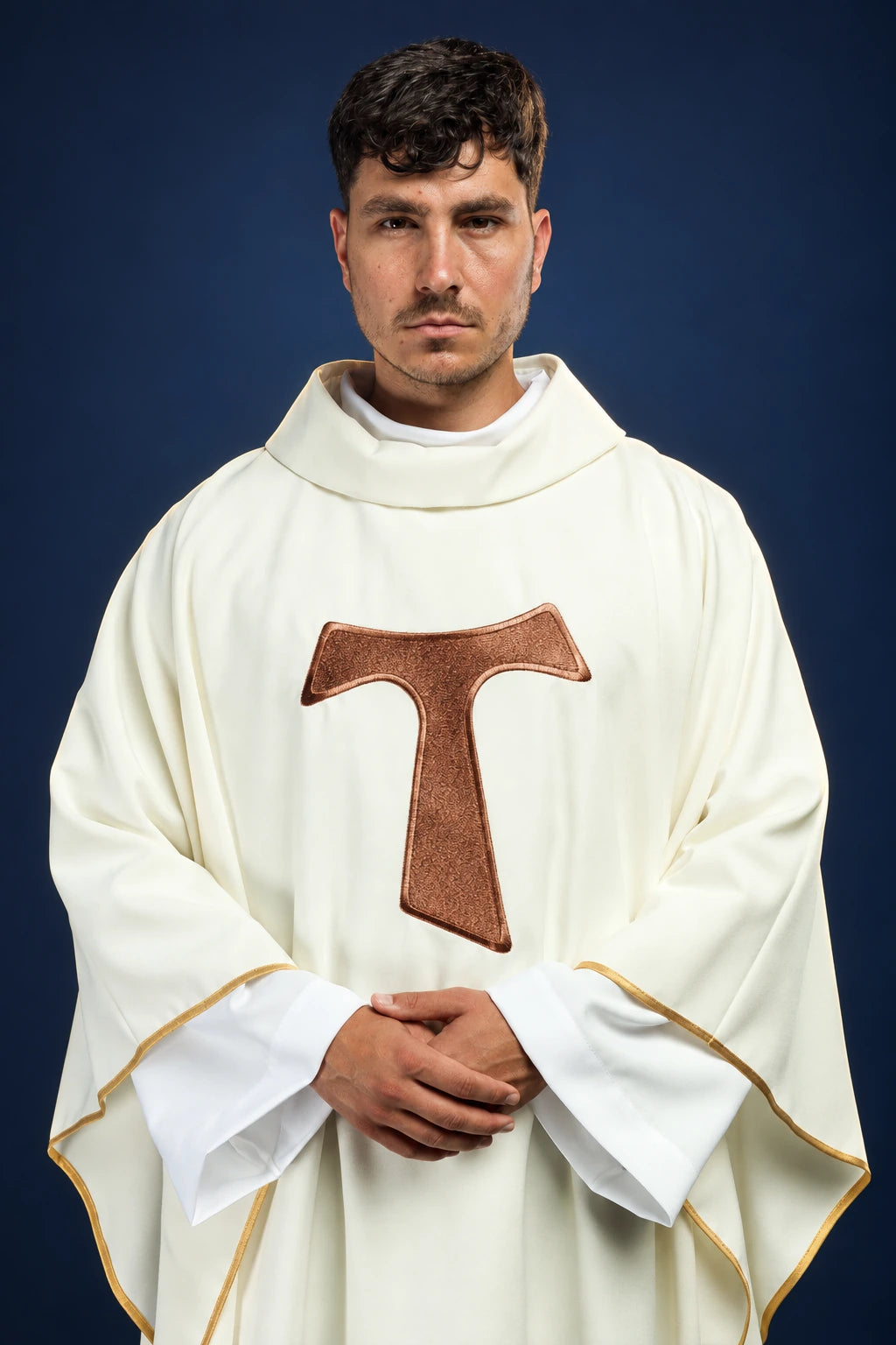 Front view of an ivory chasuble with a large brown Franciscan TAU cross on the chest