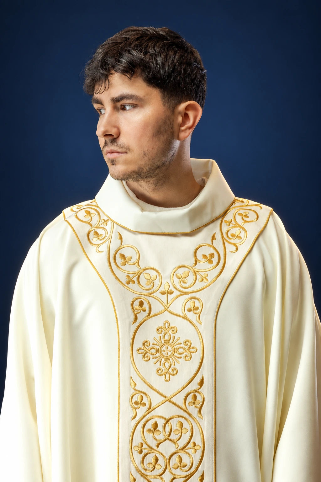 Front view of ivory chasuble with ornate gold embroidered orphrey and floral medallion detail