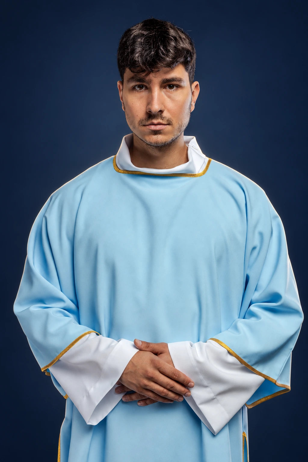 Front view of a light blue dalmatic with wide sleeves, white cuffs, and gold trim at the collar and hem