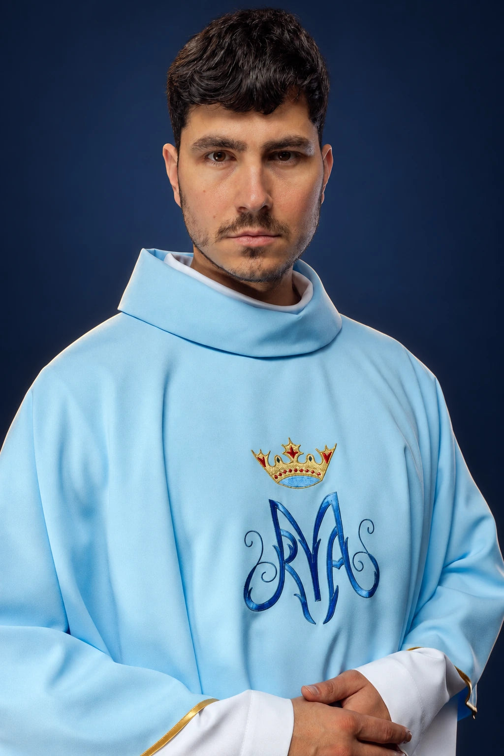 Front view of a light blue Marian chasuble with embroidered crown and stylized M on the chest