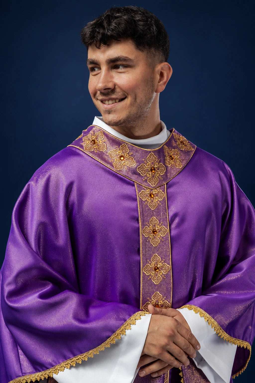 Front view of a purple chasuble with embroidered orphrey and stone-set collar accents
