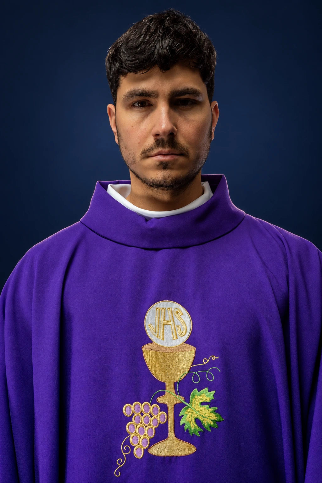 Front view of a purple chasuble with gold chalice, host, and grape embroidery on the chest