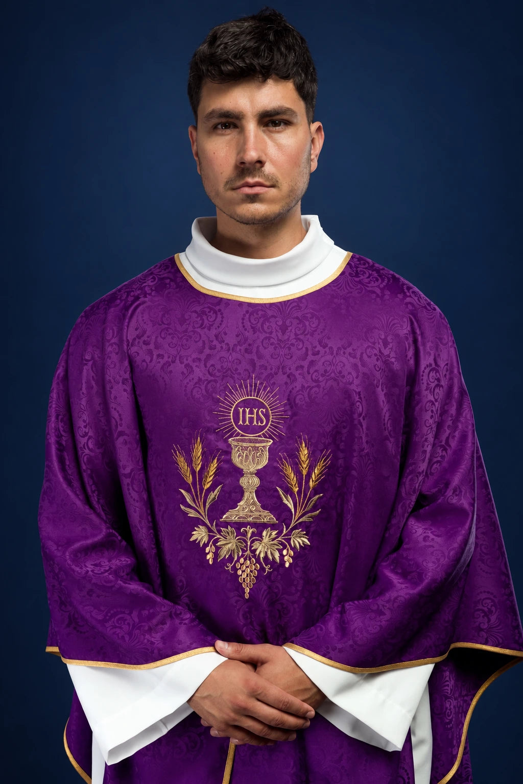 Front view of purple chasuble with gold chalice and IHS embroidery, edged in gold trim