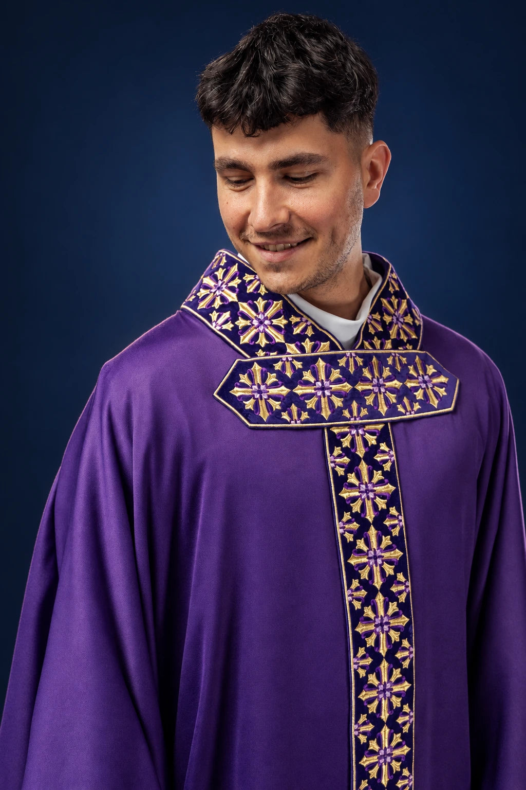 Front view of a purple chasuble with gold cross embroidery on the collar and vertical orphrey