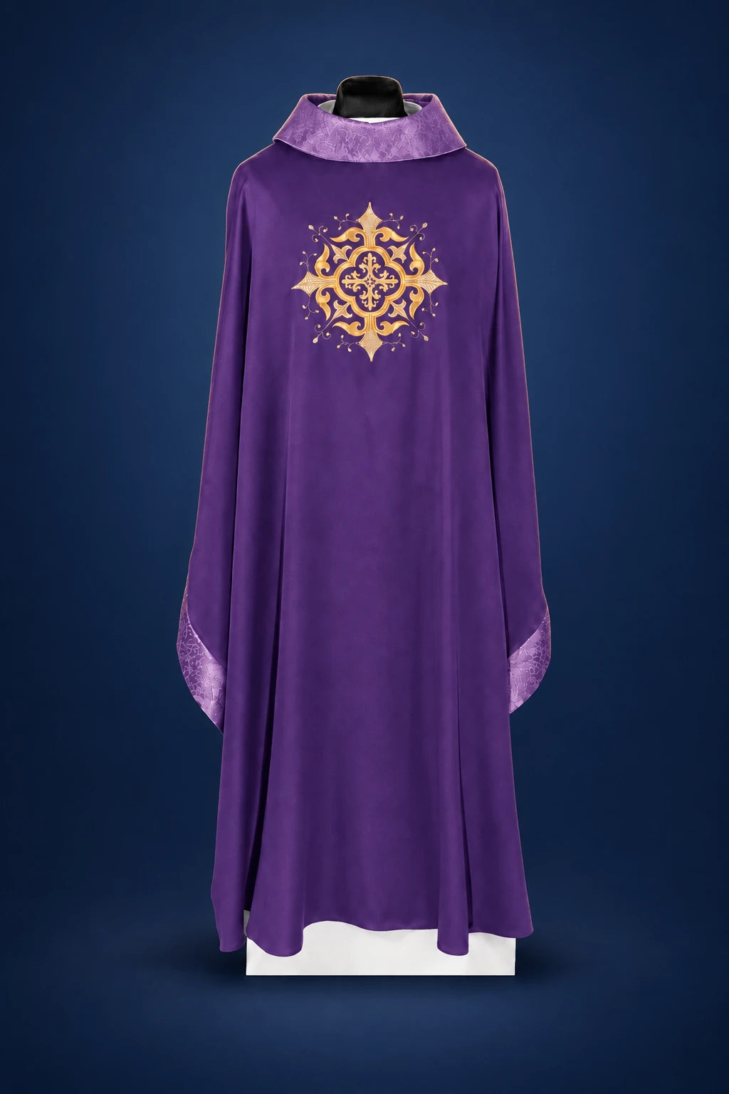 Front view of a purple chasuble with gold embroidered cross motif and purple trim at the collar and cuffs