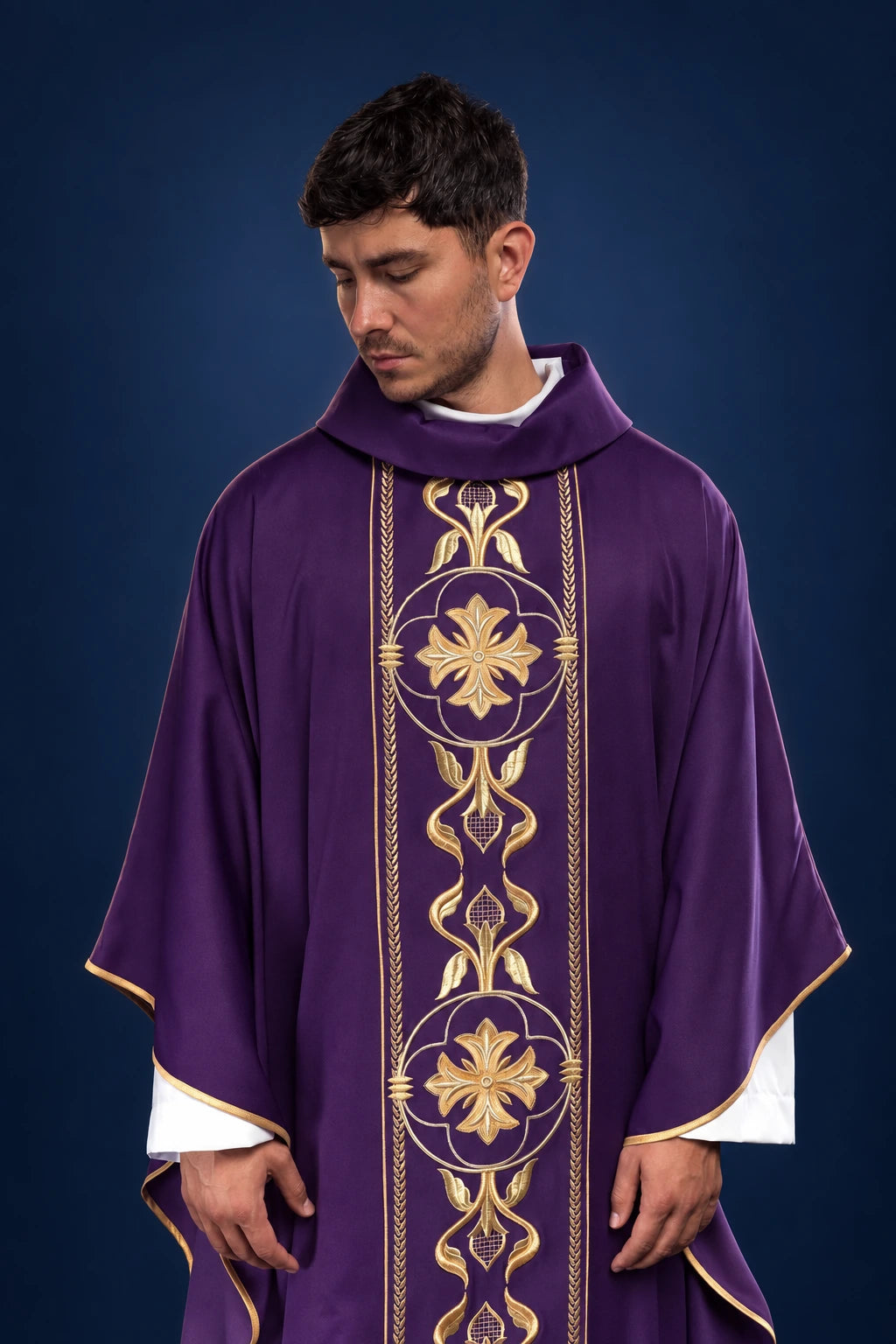 Front view of a purple chasuble with gold embroidered orphrey and floral medallions.