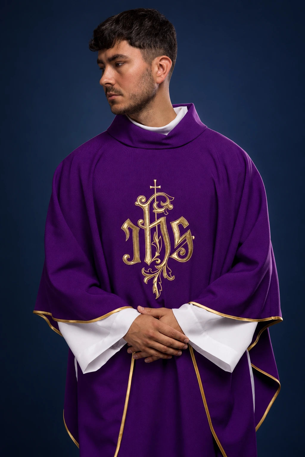 Front view of a purple chasuble with gold trim and large gold IHS embroidery on the chest