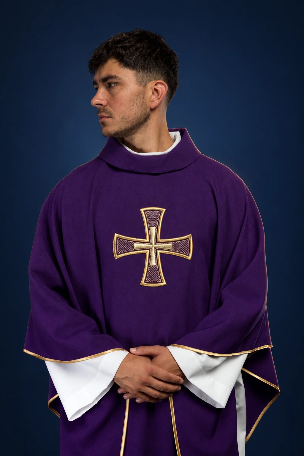 Front view of a purple chasuble with gold-trimmed cross embroidery and white under-sleeves showing