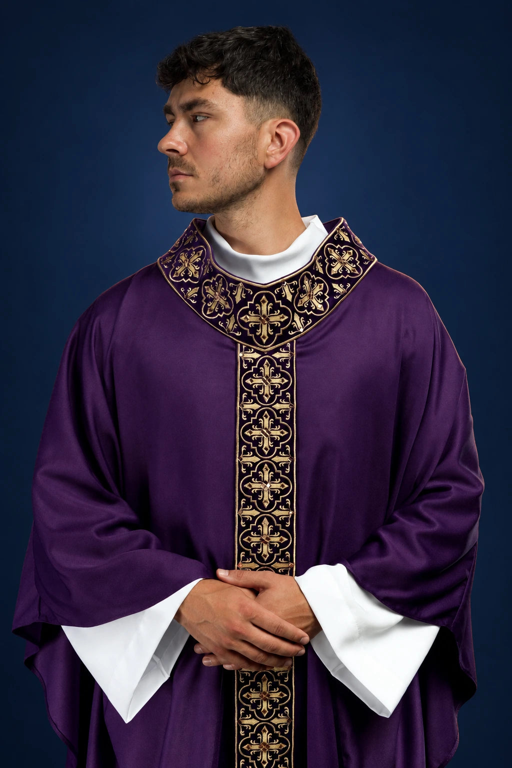 Front view of a purple chasuble with narrow embroidered orphrey and gold floral trim around the collar and center panel