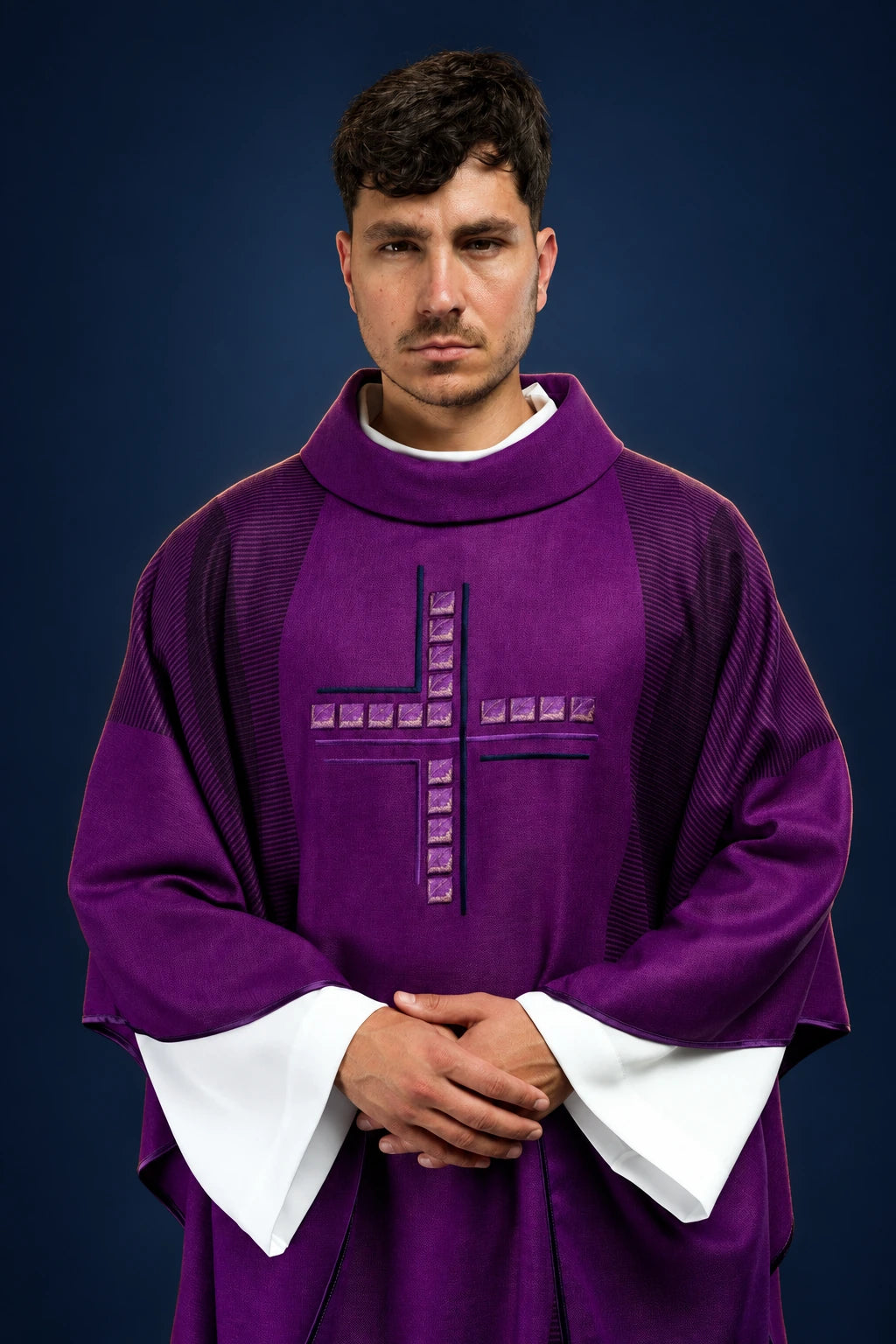 Front view of a purple chasuble with a raised cross motif on the chest