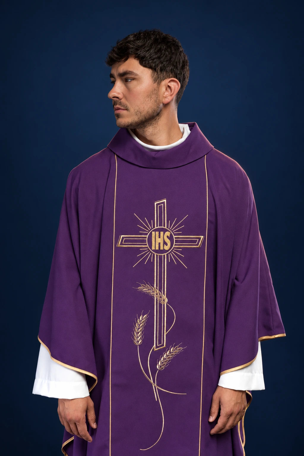 Front view of a purple chasuble with wide gold orphrey and IHS cross embroidery