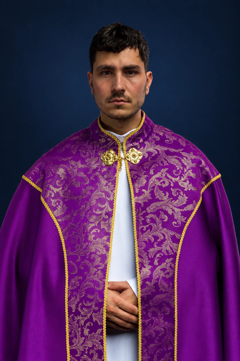 Front view of a purple cope with gold jacquard floral panel and trim, fastened at the neck