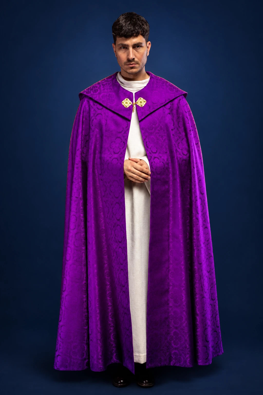 Front view of a purple jacquard cope with gold clasp at the collar