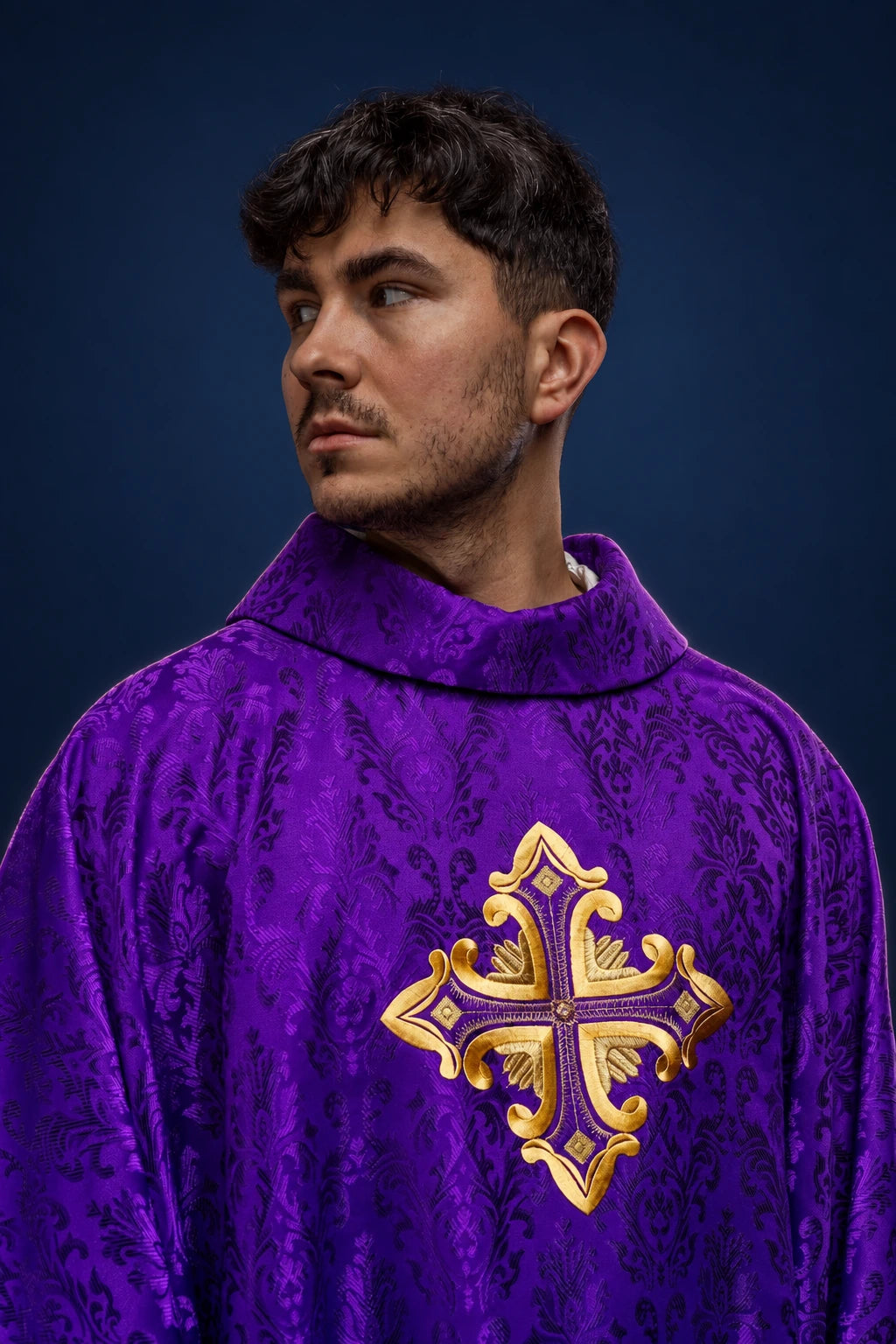 Front view of a purple patterned chasuble with a gold embroidered cross on the chest