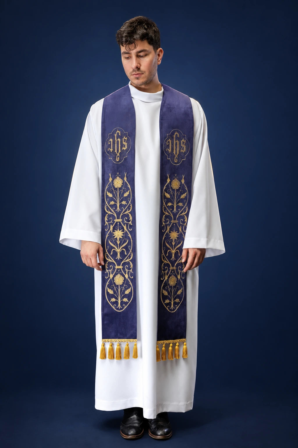 Front view of a purple stole with IHS embroidery and gold vine motifs, worn over a white alb.