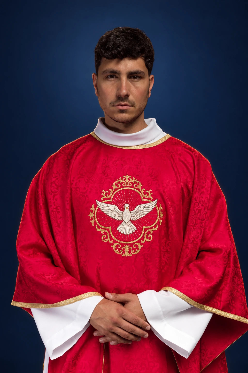 Front view of a red Catholic chasuble with gold trim and centered Holy Spirit dove embroidery
