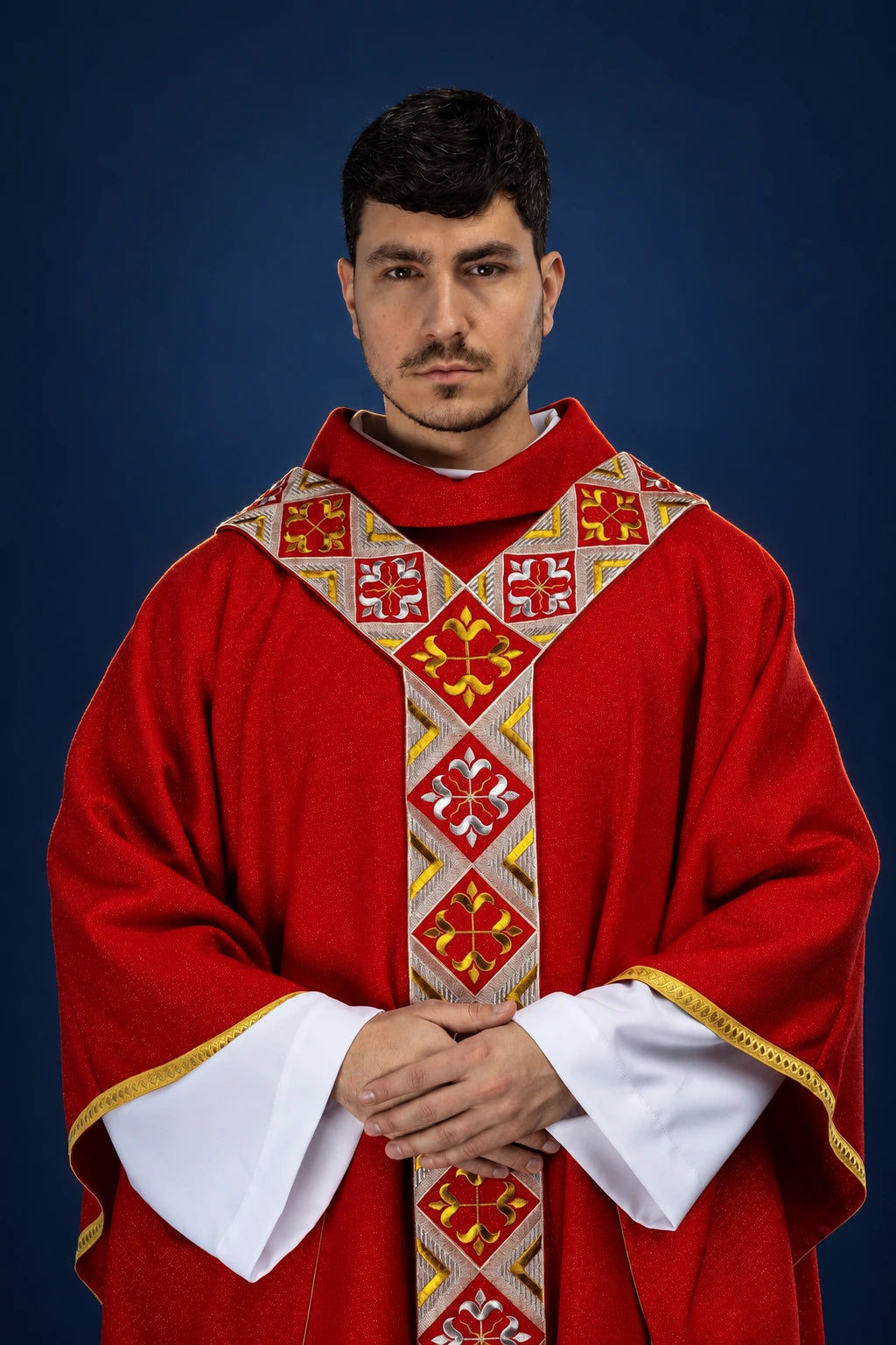 Front view of red chasuble with embroidered gold-and-white orphrey cross pattern