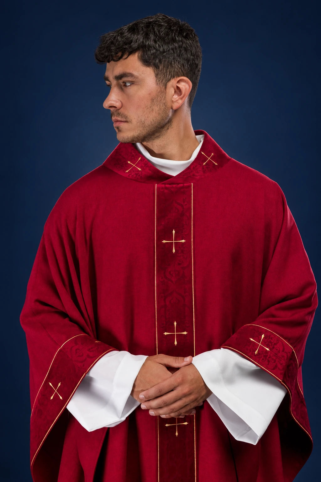 Front view of red chasuble with embroidered orphrey and cross motifs at the collar and sleeves