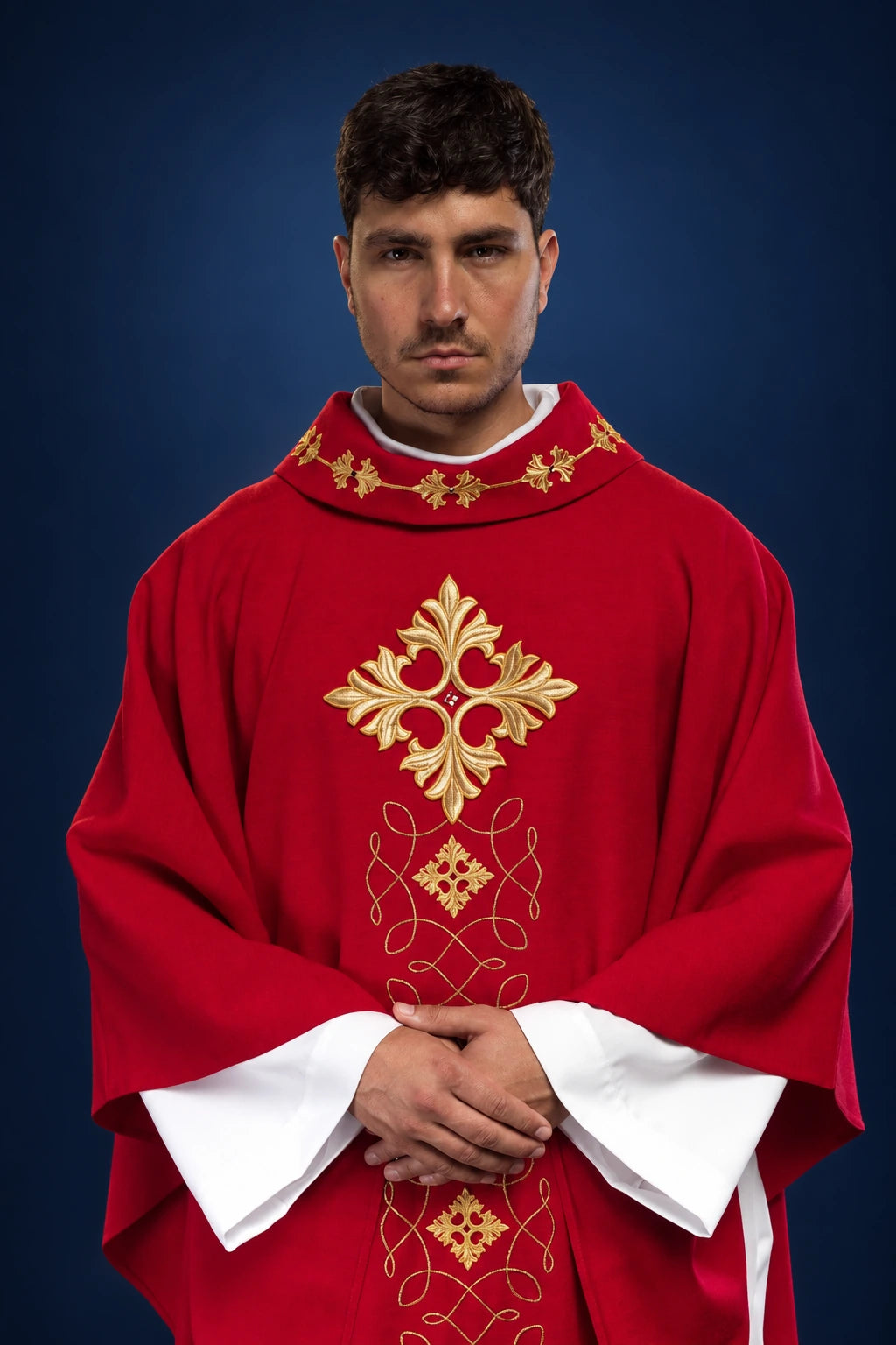 Front view of a red chasuble with gold cord embroidery and cross motifs at the collar and chest