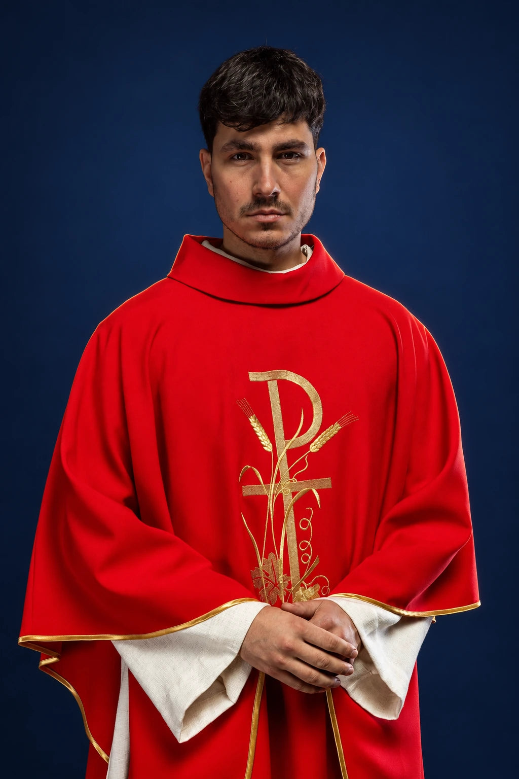 Front view of a red chasuble with gold cross embroidery and gold trim over a white alb