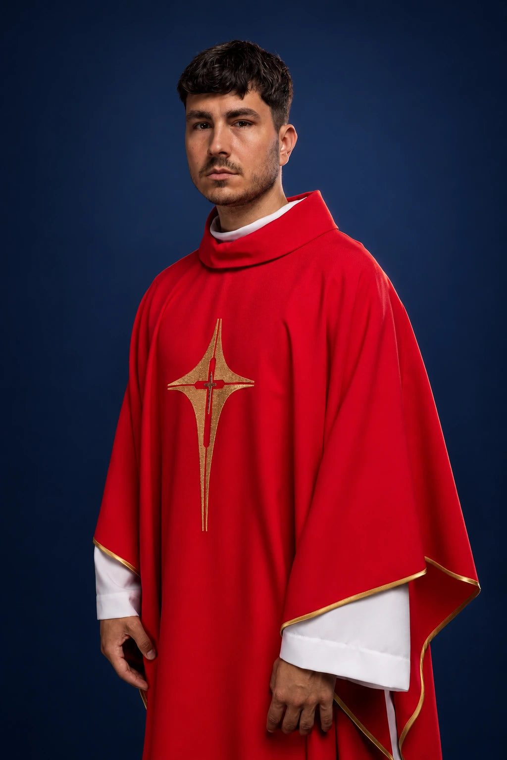 Front view of red chasuble with gold cross motif and gold trim, worn over white alb sleeves
