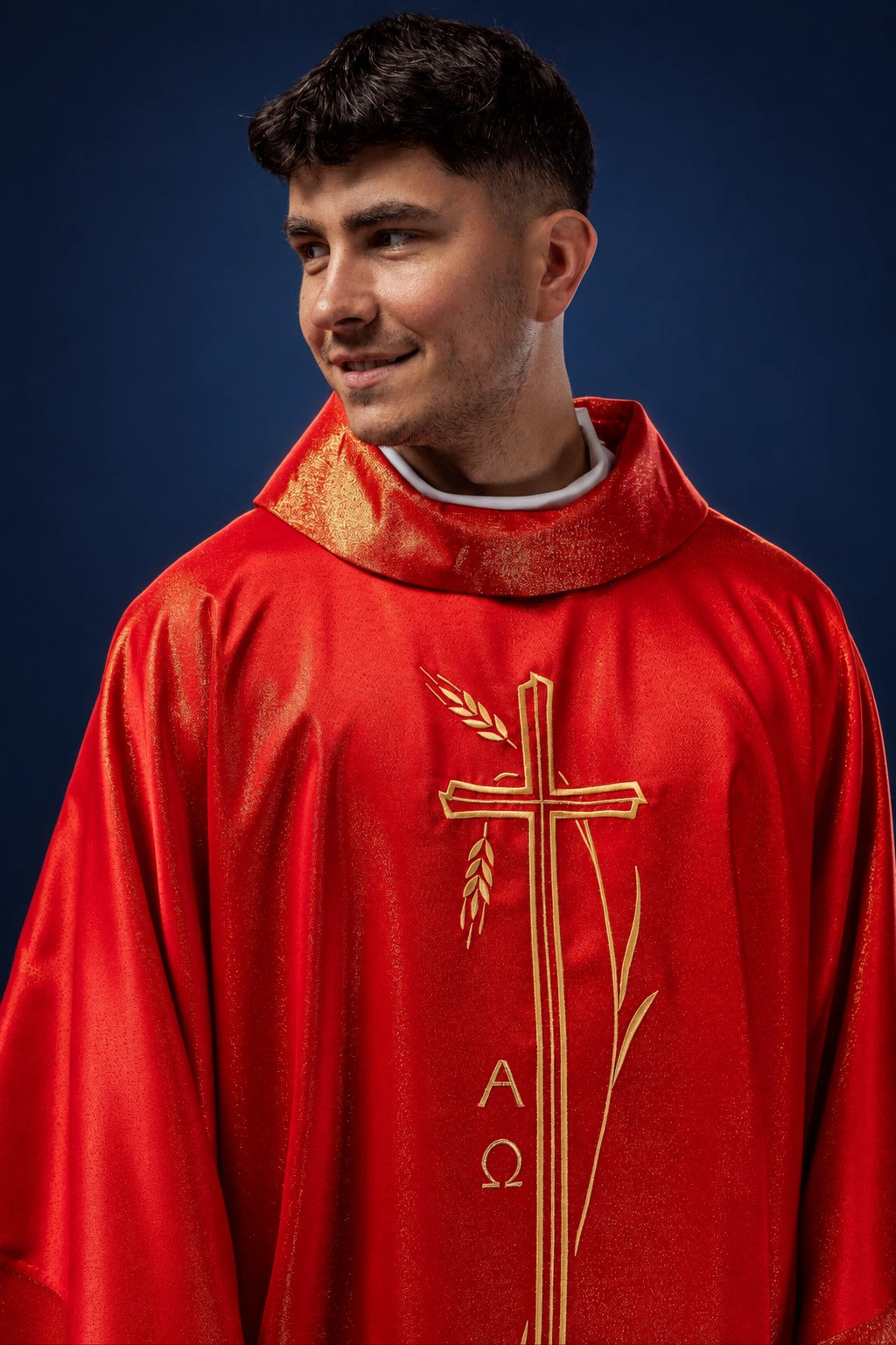 Front view of a red chasuble with gold cross and wheat embroidery, worn over a white collar