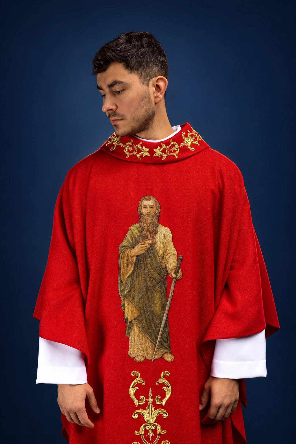 Front view of a red chasuble with gold embroidery and a central image of Saint Paul