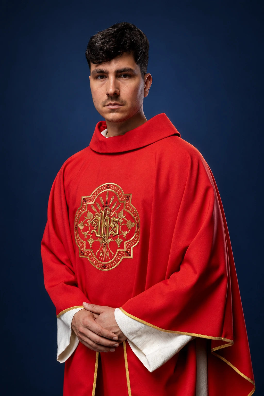 Front view of a red chasuble with gold IHS and PAX embroidery, wide sleeves and gold trim