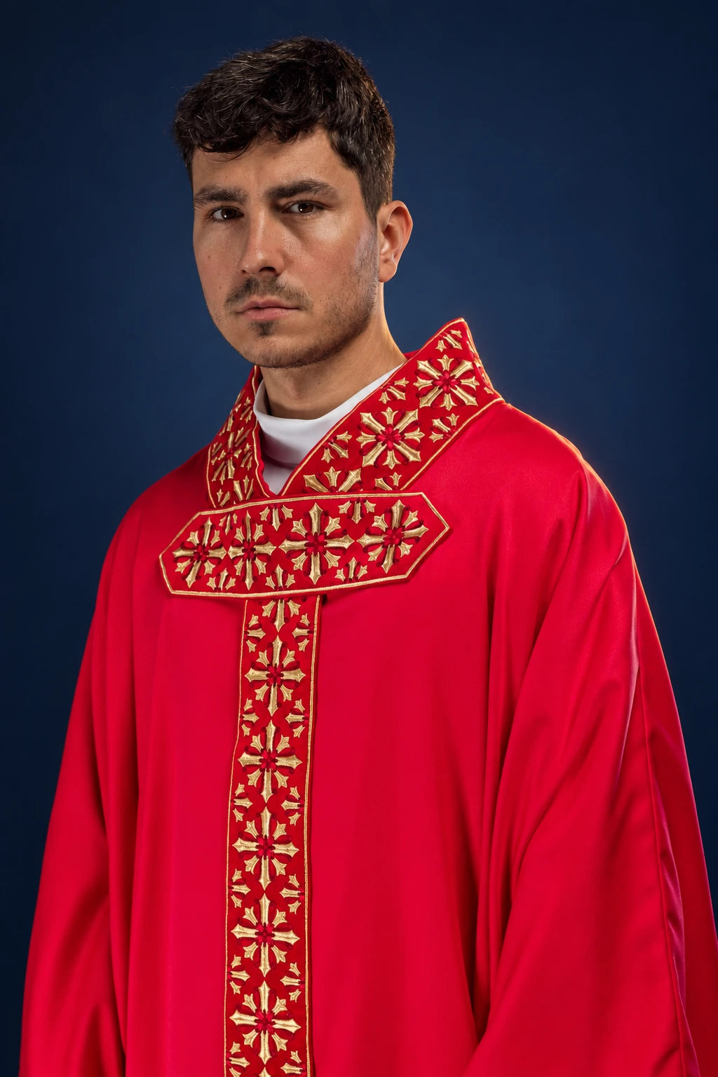 Front view of a red chasuble with gold shimmering embroidered cross panels on the collar and center front