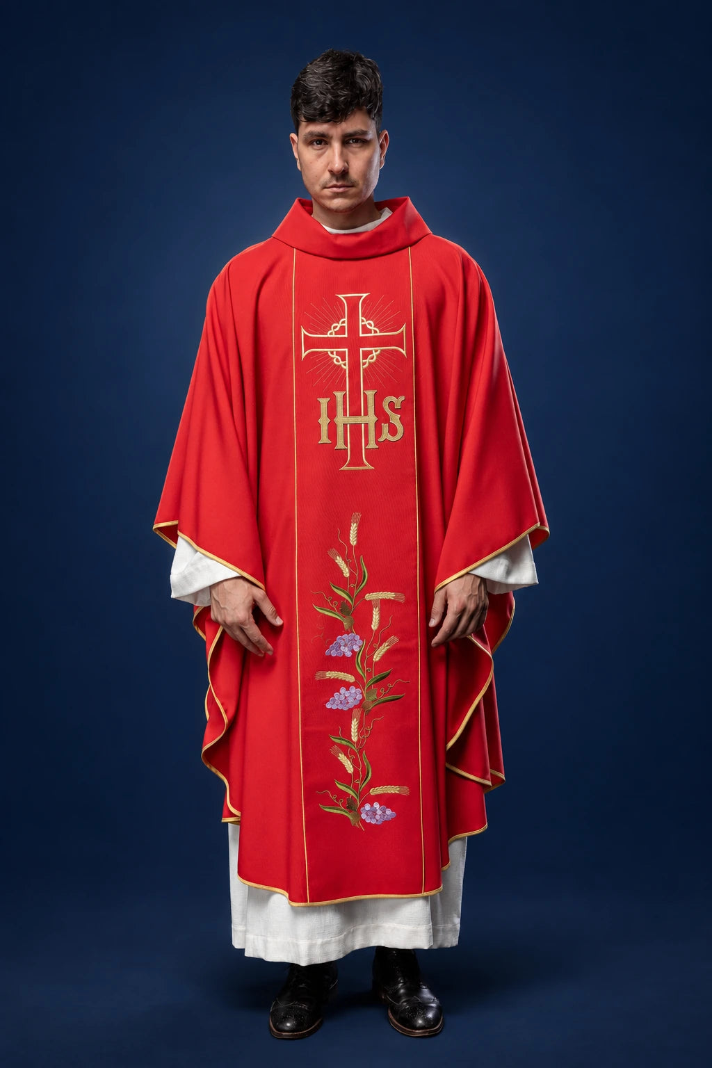 Front view of a red chasuble with gold trim, IHS cross, and wheat-and-flower embroidery