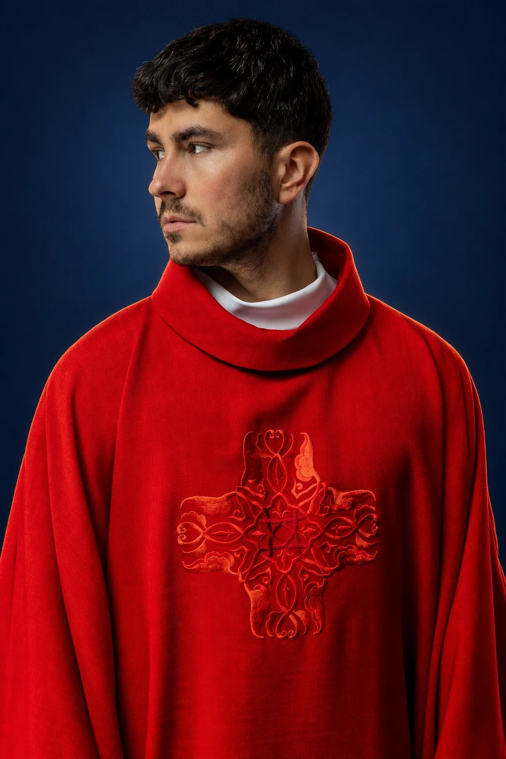Front view of a red chasuble with high collar and embroidered cross on the chest