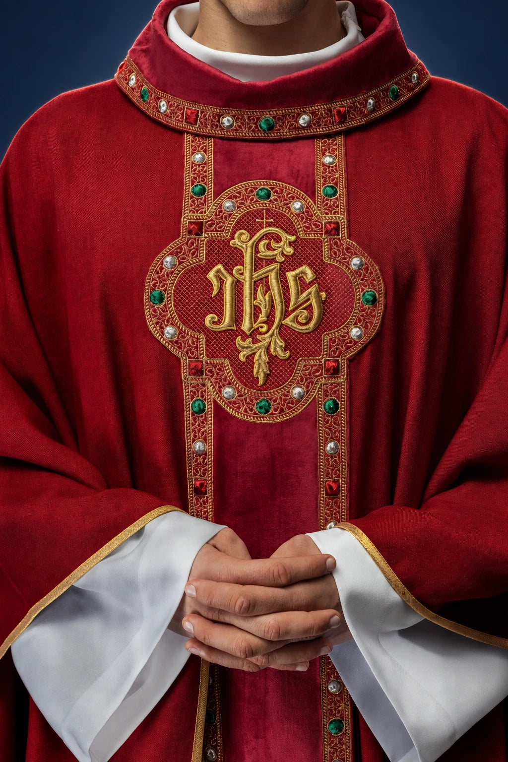 Front view of a red chasuble with ornate embroidered IHS orphrey and jeweled trim