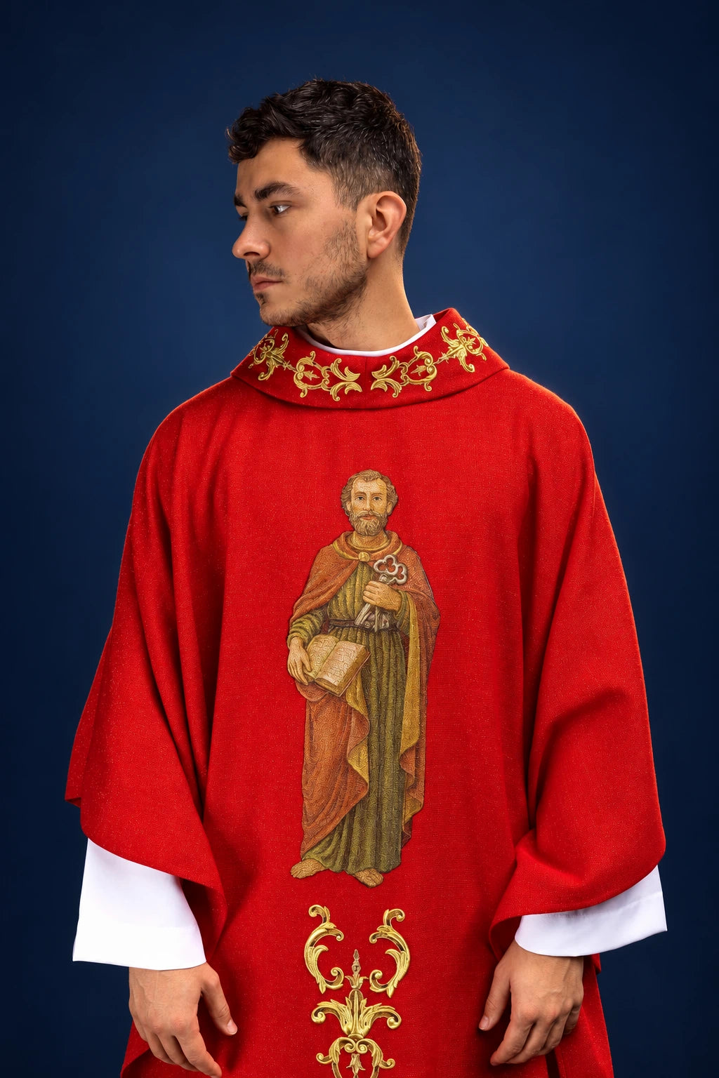 Front view of a red chasuble with Saint Peter image and ornate gold embroidery at the collar and lower front.