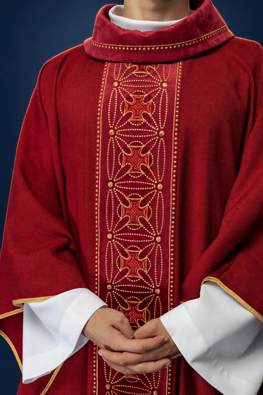 Front view of a red chasuble with a vertical embroidered orphrey and cross motif