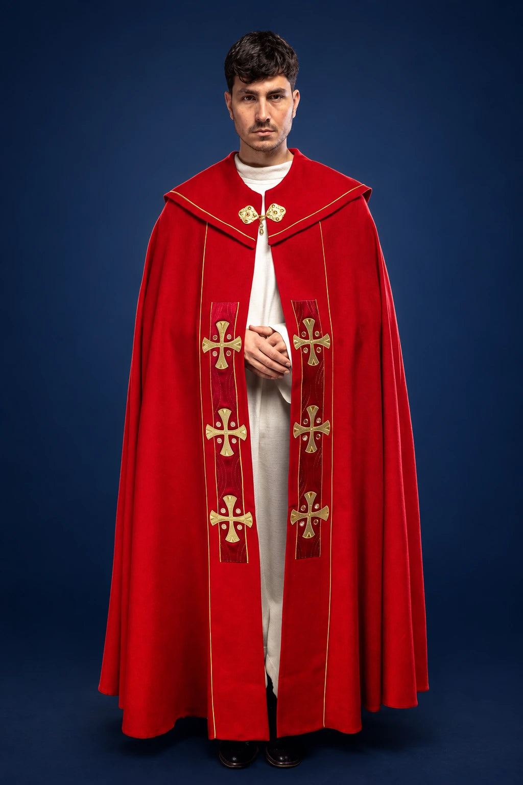 Front view of a red cope with gold embroidered crosses and red velvet trim