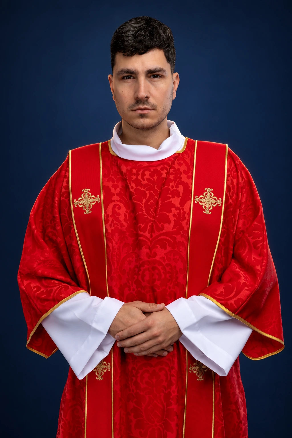 Front view of a red dalmatic with gold orphreys and embroidered crosses, worn over white sleeves