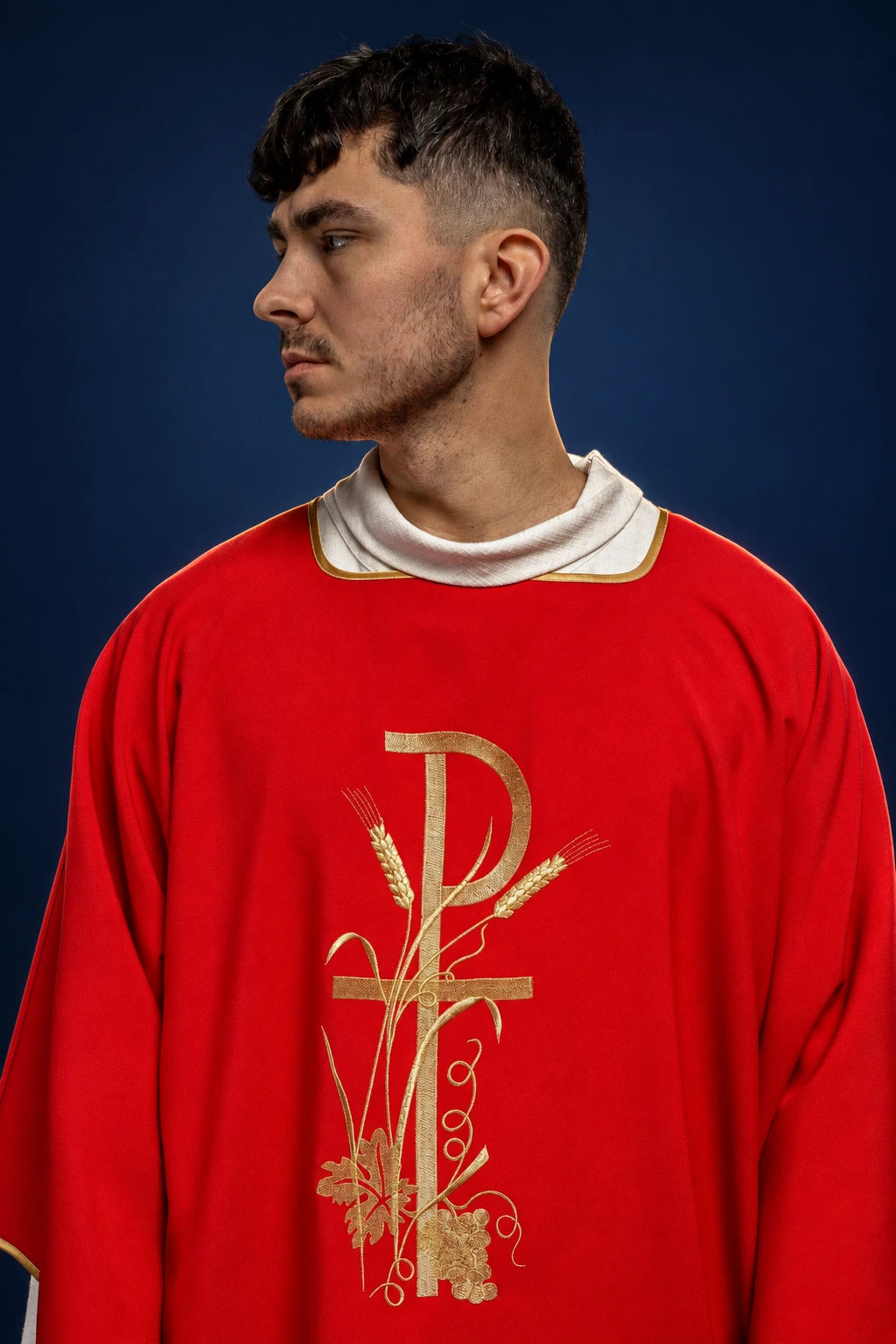 Front view of a red dalmatic with gold Pax cross embroidery on the chest