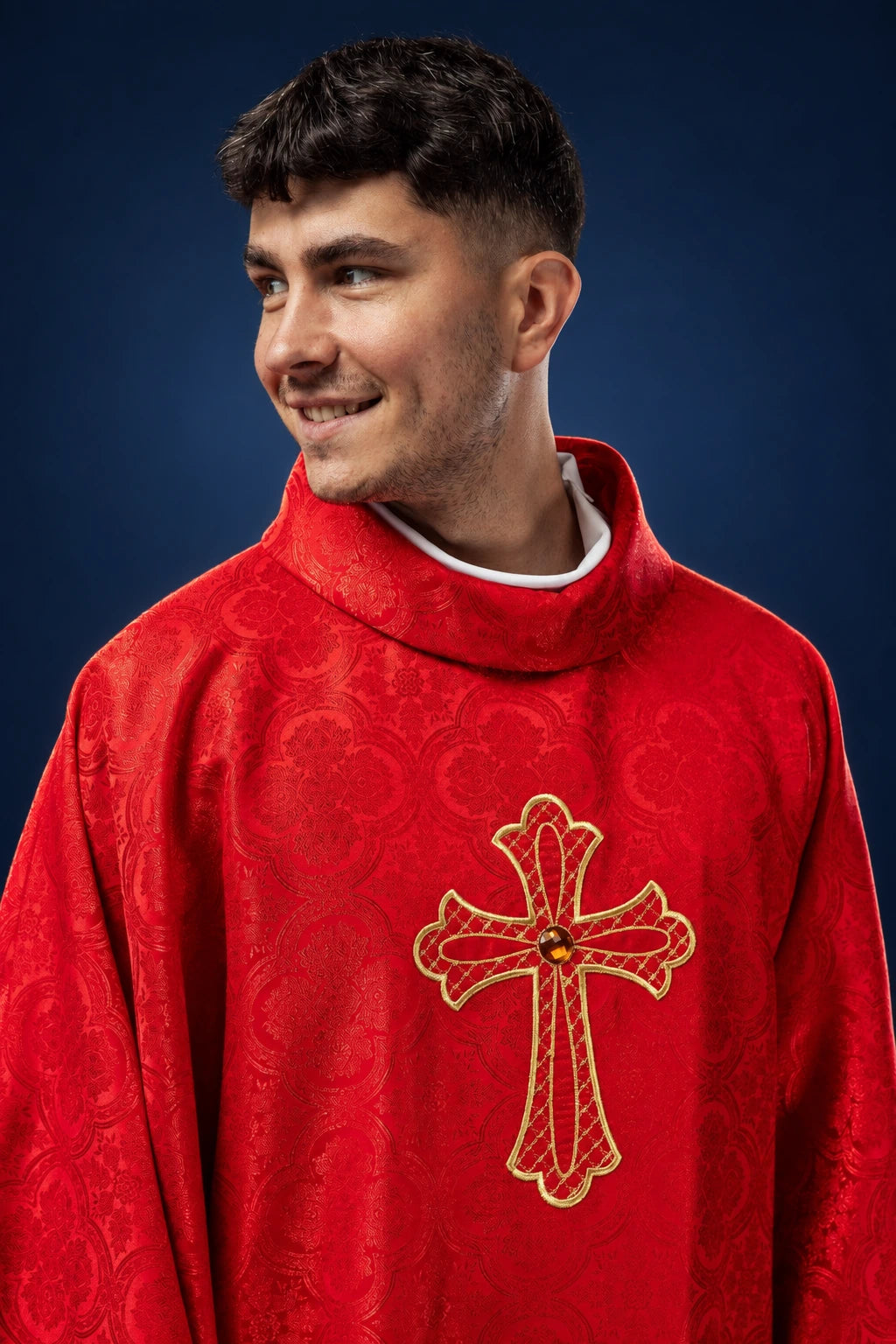 Front view of a red embroidered chasuble with a gold cross motif on the chest