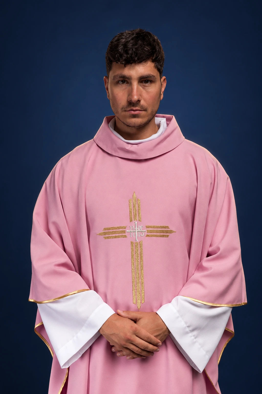 Front view of a rose chasuble with gold cross and IHS embroidery, trimmed with gold