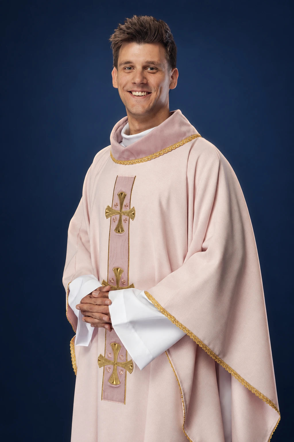 Front view of a rose chasuble with gold embroidered crosses and gold trim on the collar and edges