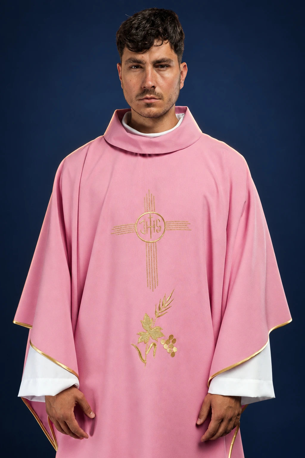 Front view of a rose chasuble with gold IHS cross and embroidered vine motif