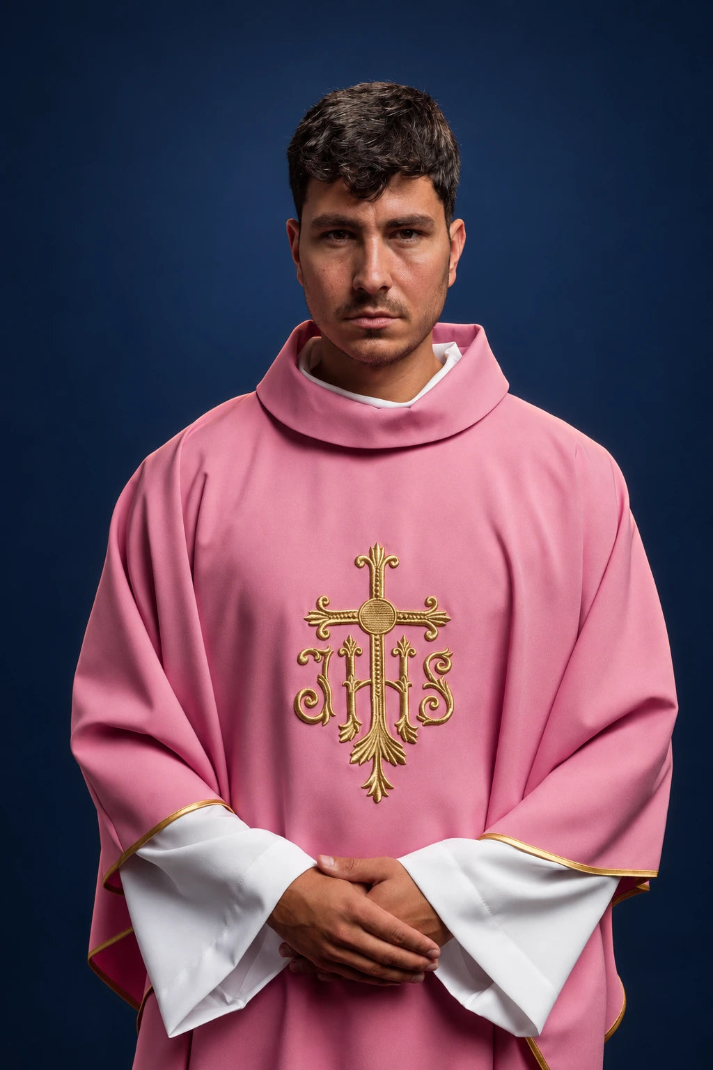 Front view of a rose chasuble with raised gold JHS cross embroidery and gold trim at the sleeves and hem