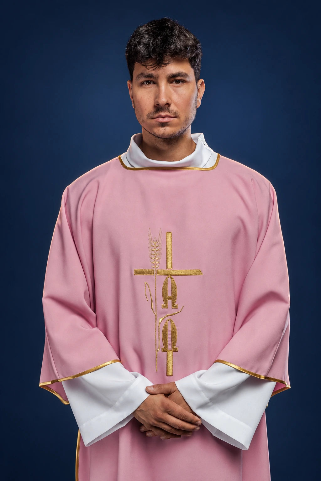 Front view of a rose dalmatic with gold Alpha and Omega embroidery and gold trim